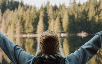 Woman with outstretched hands in nature | Dockside Cannabis