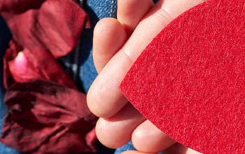 Heart-shaped paper cut-out in hands | Dockside Cannabis