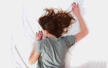 Woman sleeping on white sheets | Dockside Cannabis