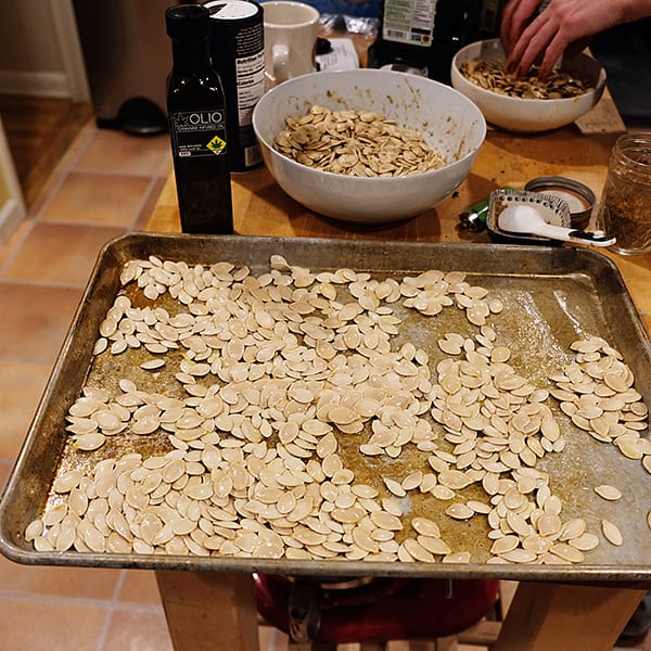 seeds scattered on a pan with bottle of oil and bowl of seeds in the background | Dockside Cannabis