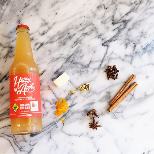 Happy Apple brand glass bottle next to butter slice and various spices including cinnamon | Dockside Cannabis