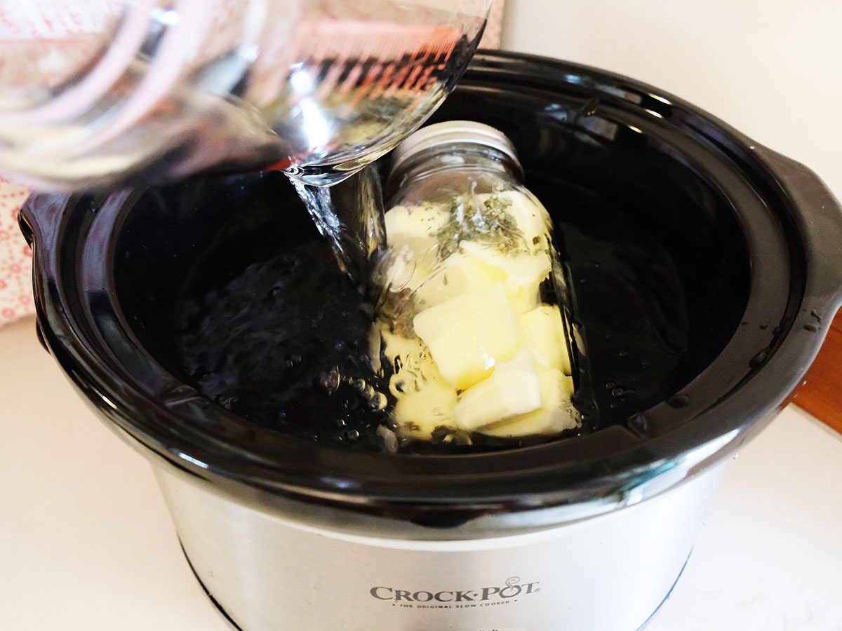 butter and cannabis combined in a jar and placed inside a crock pot with water